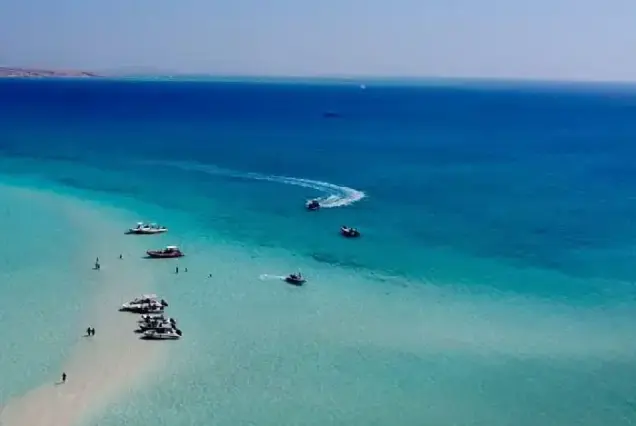 Aerial view of several private speedboats anchored at the sandbar of Abu Minqar Island (White Island) in Hurghada.