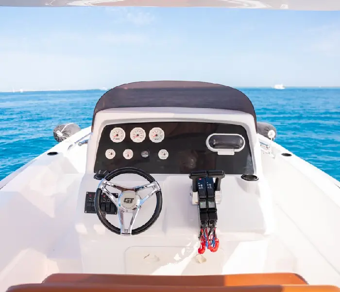 The steering wheel and dashboard of a modern private speedboat overlooking the open blue sea in Hurghada.