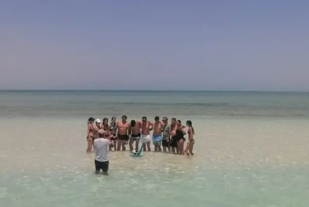 Group photo of private boat tour guests taking pictures at Abu Minqar Sandbar Hurghada.