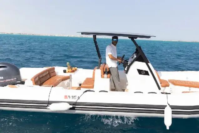 Captain driving a private speedboat with fresh fruit platter in Hurghada